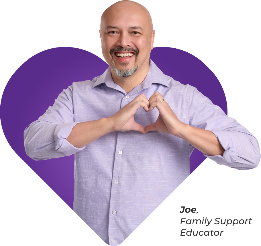 Joe, Acadia Family Support Educator making heart with hands.