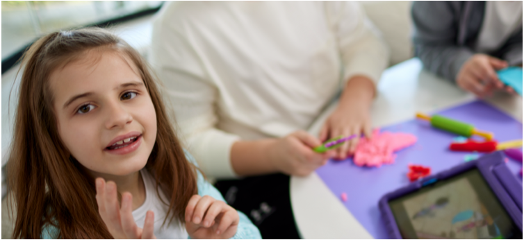 Kate, age 9, living with Rett syndrome, playing with a tablet and doing crafts with her mom mobile