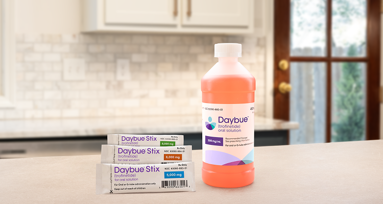 DAYBUE® (trofinetide) ready-to-take liquid next to DAYBUE® STIX (trofinetide) individual packets.